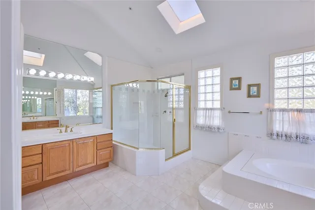 a large bathroom with a tub sink and mirror
