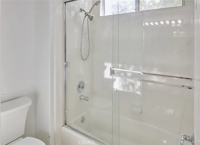 a bathroom with a shower and a toilet