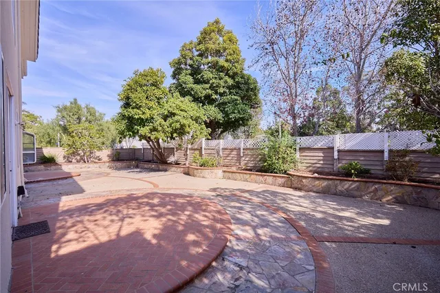 a view of a backyard with plants and a garden