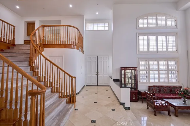 a view of hall way with furniture and staircase