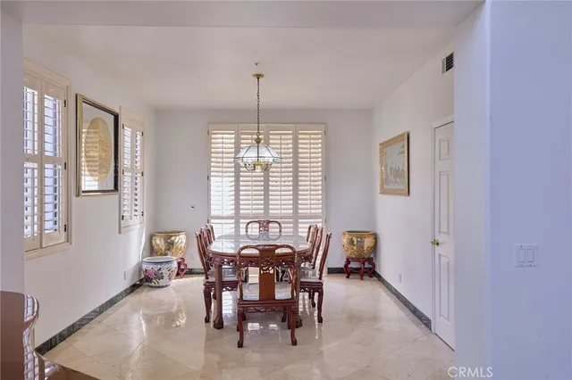 a view of a dining room with furniture and chandelier