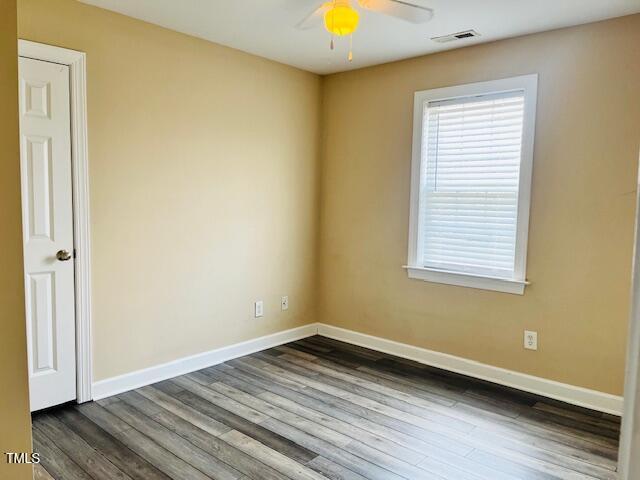 151 Bear Oak Drive Smithfield, NC 27577 - Photo 11 of 16 an empty room with wooden floor and windows