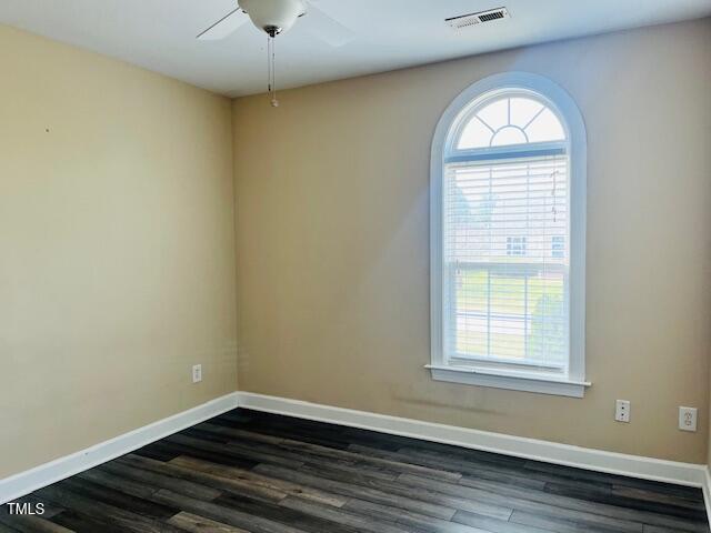 151 Bear Oak Drive Smithfield, NC 27577 - Photo 12 of 16 an empty room with wooden floor and windows