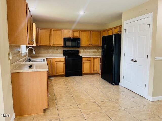 151 Bear Oak Drive Smithfield, NC 27577 - Photo 7 of 16 a kitchen with stainless steel appliances a refrigerator sink stove and cabinets