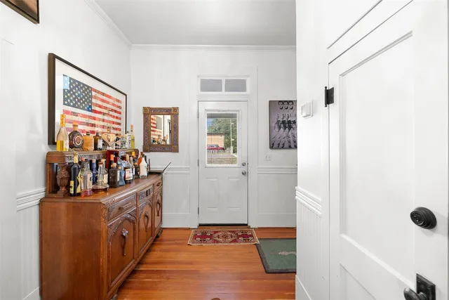 a hallway with a baby crib and dresser