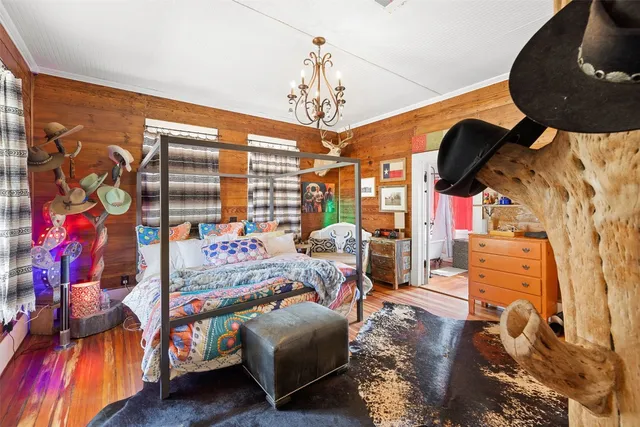 a bedroom with furniture and a chandelier