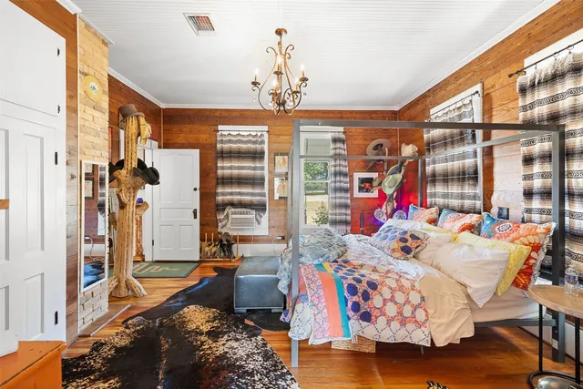 a bedroom with furniture and a chandelier
