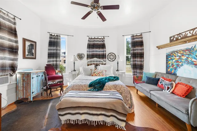 a bedroom with furniture and a window