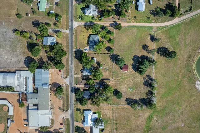 an aerial view of a residential houses with outdoor space