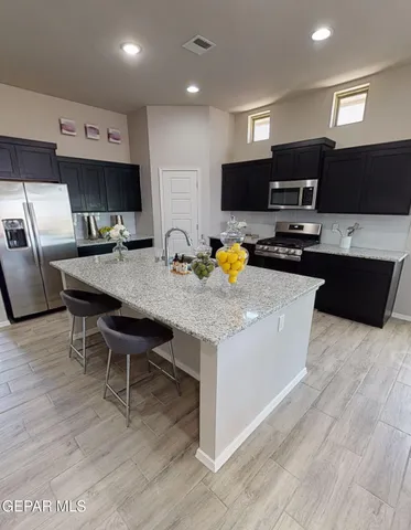 a kitchen with a wooden floor and breakfast area