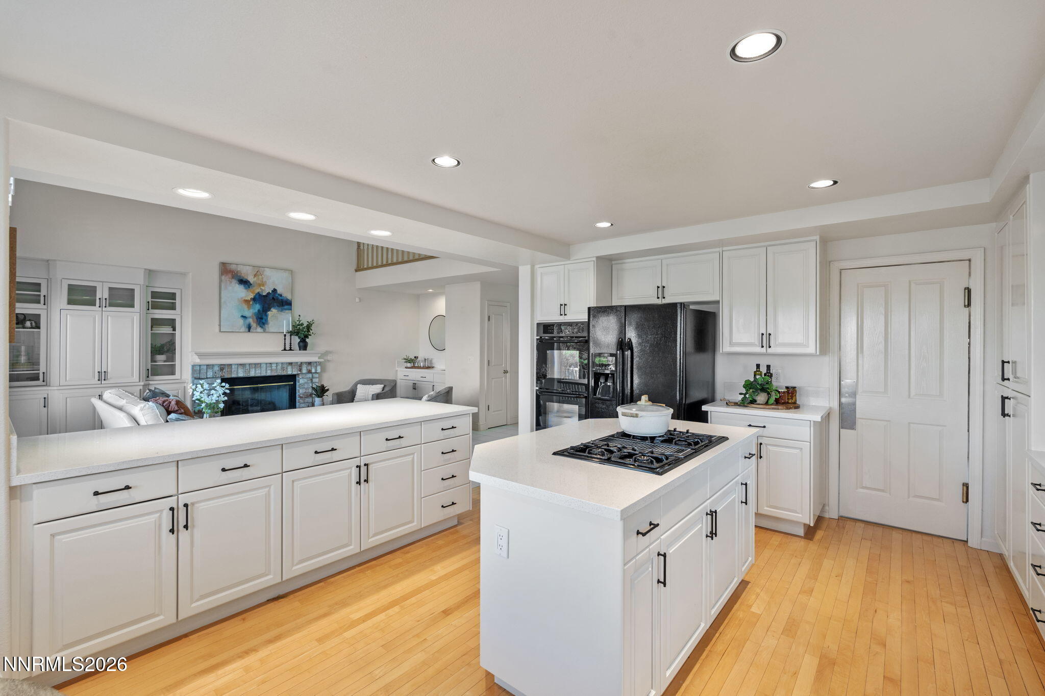 6186 Squires Lane Reno, NV 89519 - Photo 14 of 57 a kitchen with white cabinets and stainless steel appliances
