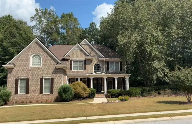 a front view of a house with a yard