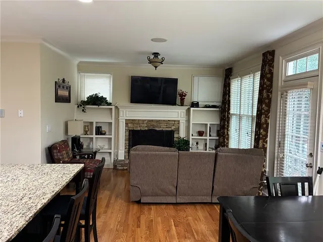 a living room with furniture fireplace and flat screen tv