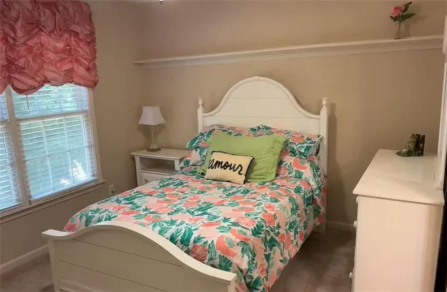 a bedroom with a bed and a painting on the wall