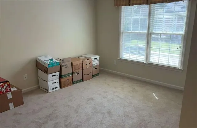 an empty room with window and furniture