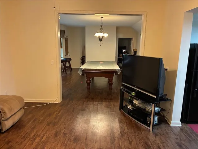 a view of a room with wooden floor and white walls
