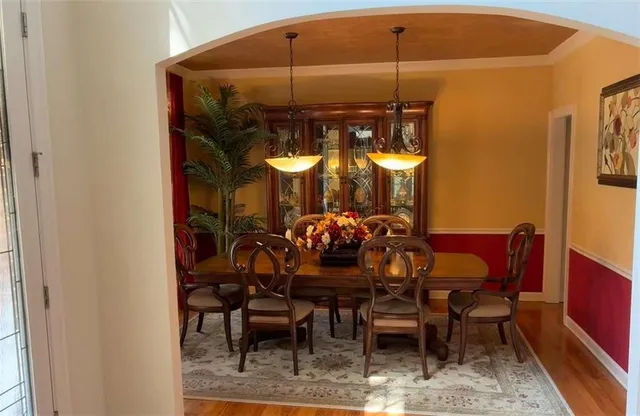 a view of a dining room with furniture and chandelier