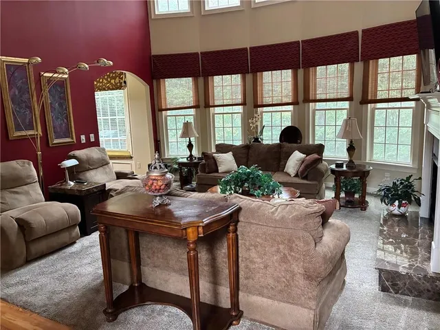 a living room with furniture and large windows