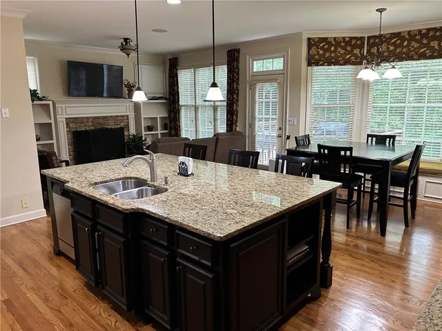 a kitchen with a kitchen island a stove a table and chairs