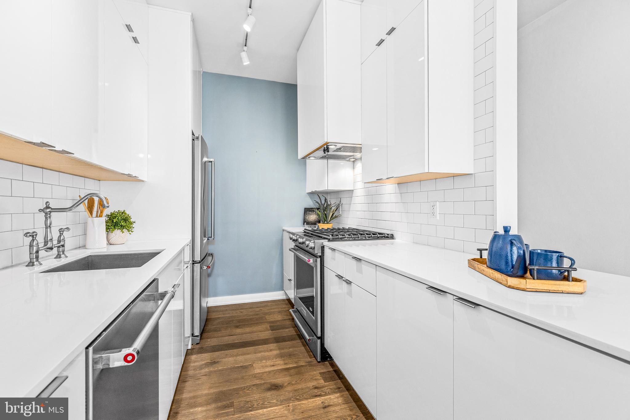 1380 Quincy Street Northwest, Unit 3E Washington, DC 20010 - Photo 9 of 42 a kitchen with a sink stove and refrigerator
