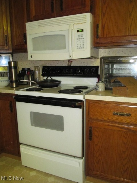 9735 Chillicothe Road, Unit 2 Willoughby, OH 44094 - Photo 22 of 49 Kitchen featuring white electric range and tasteful backsplash
