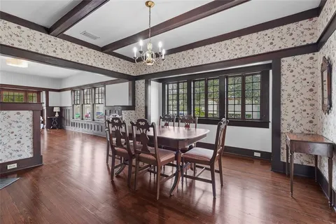 a view of a dining room with furniture wooden floor and chandelier