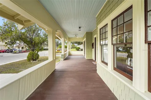 a view of a porch with a table and chairs