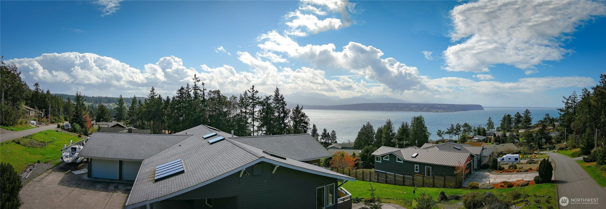 85 Quinault Loop Port Townsend, WA 98368 - Photo 3 of 34 an aerial view of a house with swimming pool and lake view