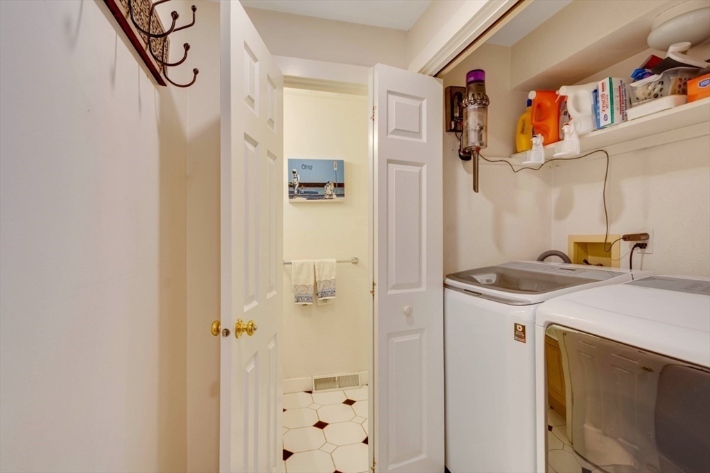 8 Aspen Circle Framingham, MA 01701 - Photo 27 of 31 a utility room with cabinets washer and dryer