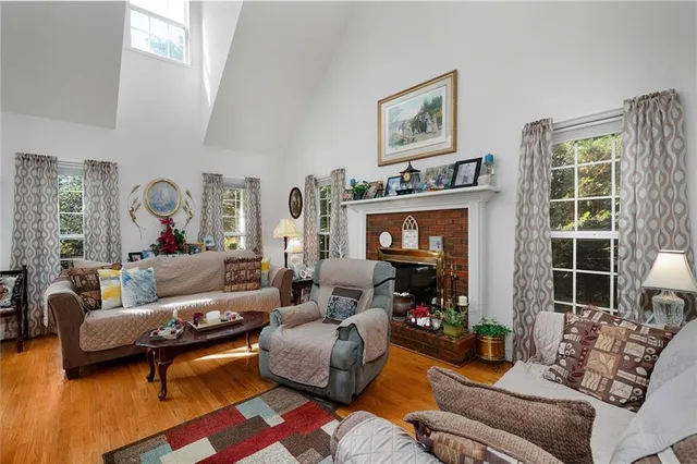 a view of a dining room with furniture a chandelier and wooden floor