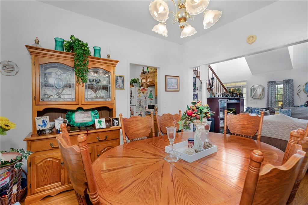2467 Owens Gin Road Northeast Resaca, GA 30735 - Photo 20 of 44 a view of a dining room with furniture a chandelier and wooden floor