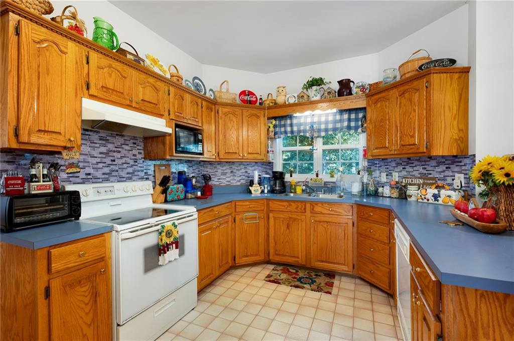 2467 Owens Gin Road Northeast Resaca, GA 30735 - Photo 21 of 44 a kitchen with stainless steel appliances granite countertop a sink a stove and a refrigerator