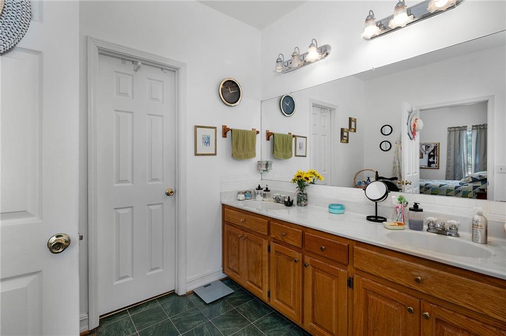2467 Owens Gin Road Northeast Resaca, GA 30735 - Photo 30 of 44 a bathroom with double vanity sink and a mirror