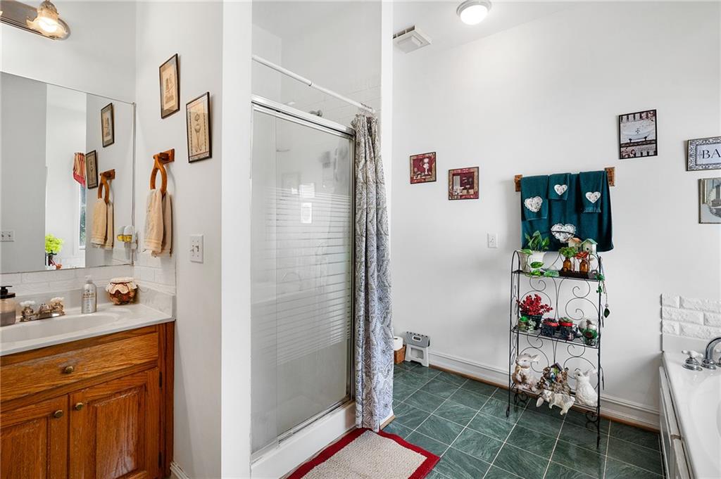 2467 Owens Gin Road Northeast Resaca, GA 30735 - Photo 31 of 44 a bathroom with a sink mirror and shower