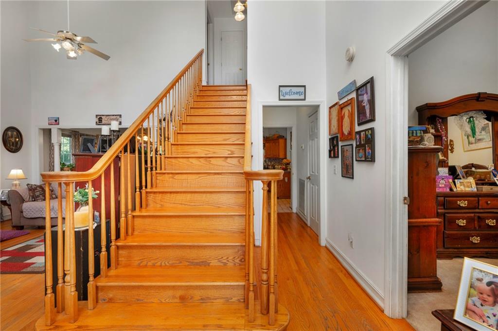 2467 Owens Gin Road Northeast Resaca, GA 30735 - Photo 33 of 44 a view of staircase with lots of frames on wall and wooden floor