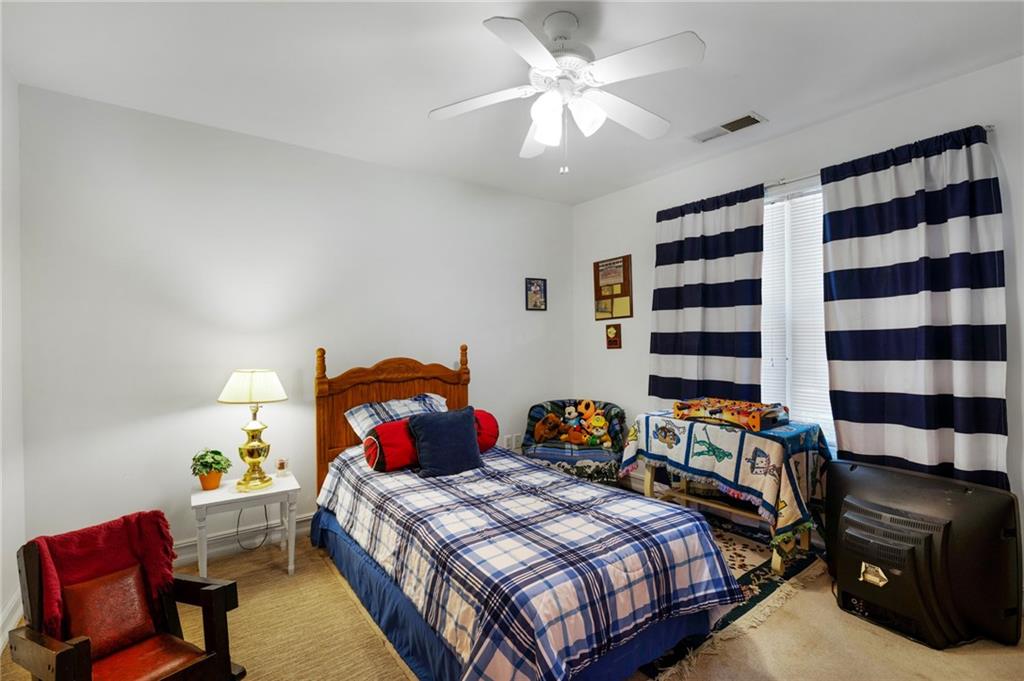 2467 Owens Gin Road Northeast Resaca, GA 30735 - Photo 35 of 44 a bedroom with a bed and a chandelier