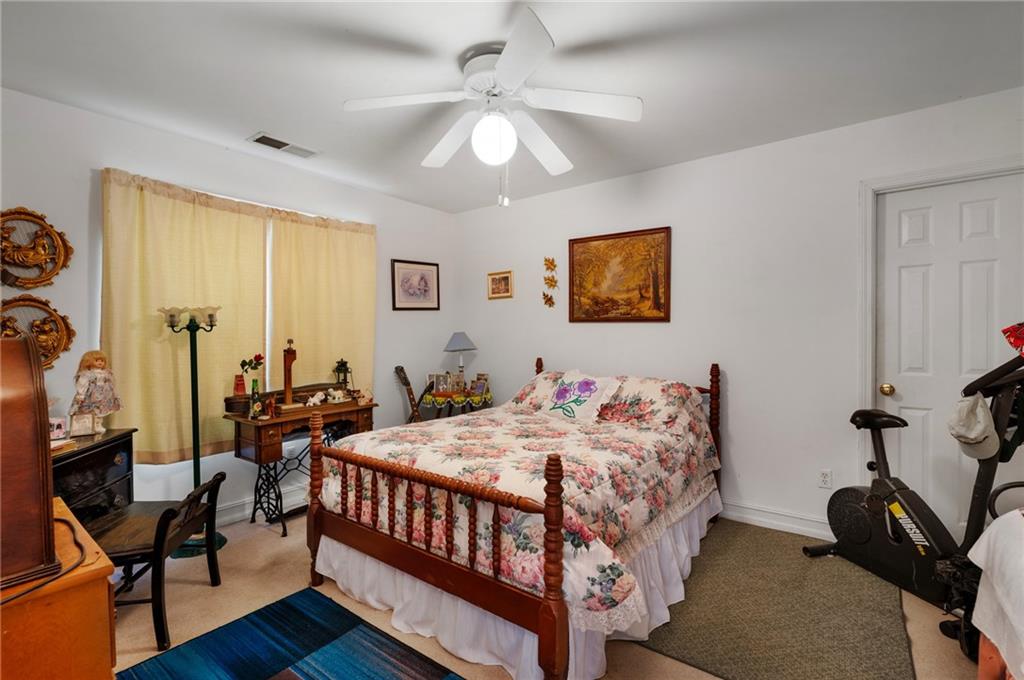 2467 Owens Gin Road Northeast Resaca, GA 30735 - Photo 36 of 44 a bedroom with a bed and a chandelier