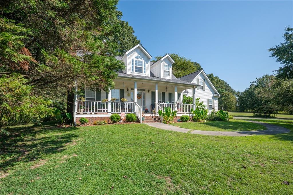 2467 Owens Gin Road Northeast Resaca, GA 30735 - Photo 7 of 44 a front view of a house with a yard table and chairs