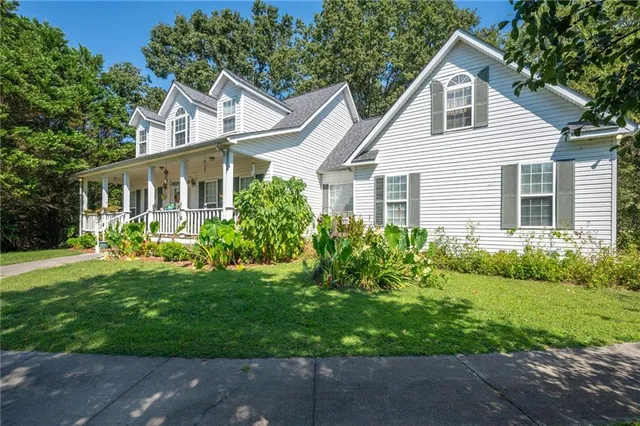 a view of a backyard with large trees