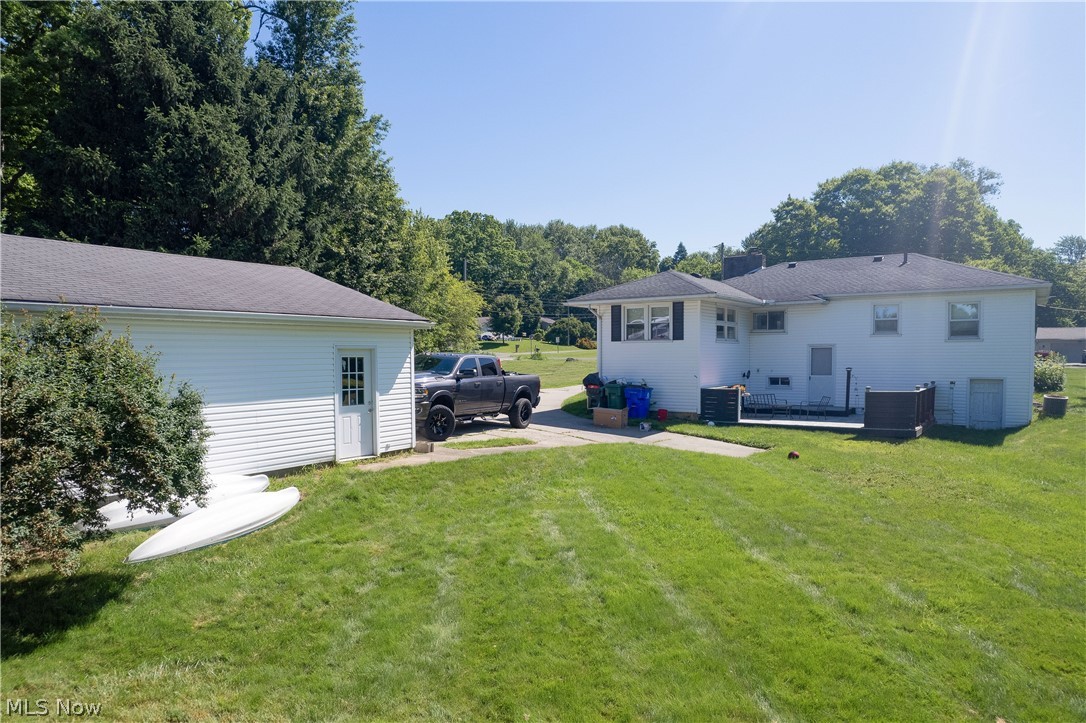 3659 Morrow Road Kent, OH 44240 - Photo 34 of 39 Expansive lawn area featuring a detached garage with white siding and a black shingle roof