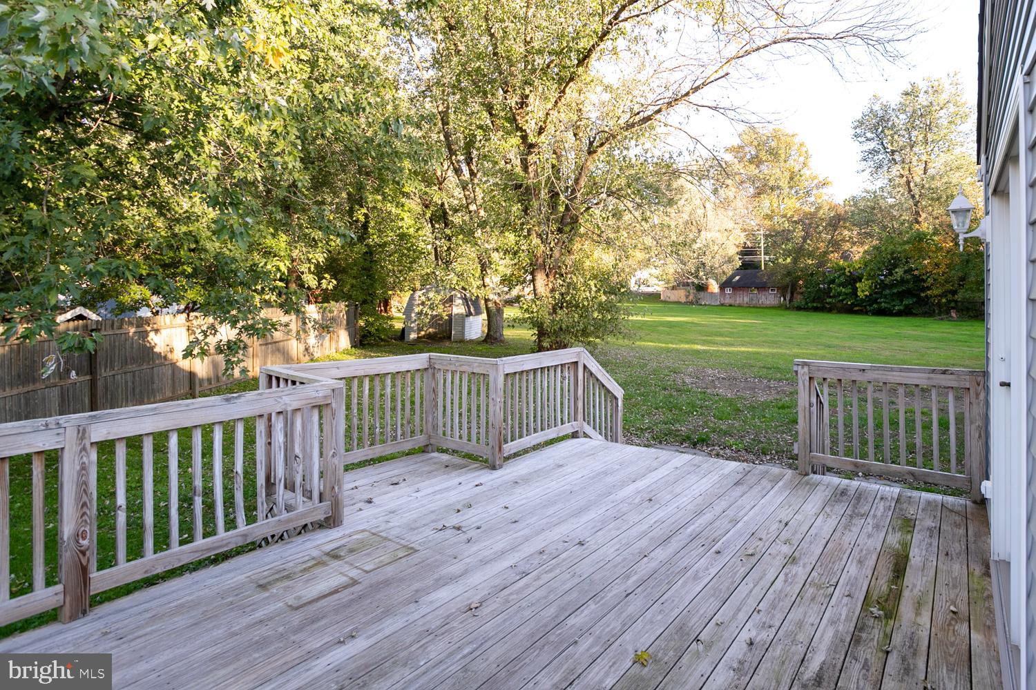 907 Bordentown Road Columbus, NJ 08022 - Photo 21 of 25 a view of a deck with a yard and wooden fence