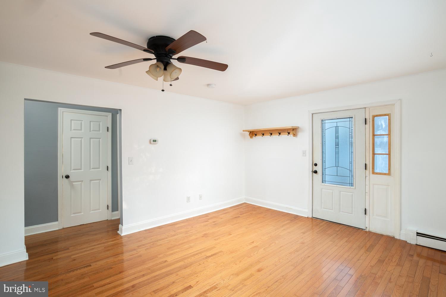 907 Bordentown Road Columbus, NJ 08022 - Photo 6 of 25 an empty room with wooden floor and windows