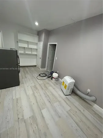 a room with a wooden floor and shoes