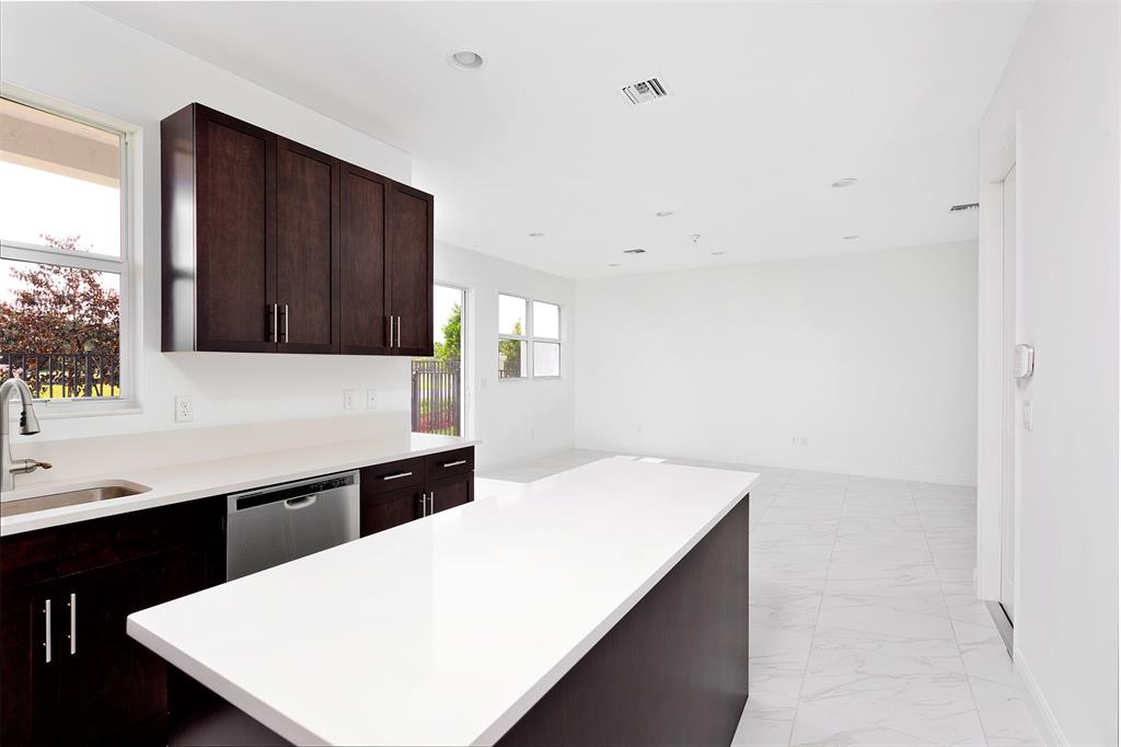 6947 Pines Circle, Unit 21 Pompano Beach, FL 33073 - Photo 11 of 31 a kitchen with a sink a stove and cabinets