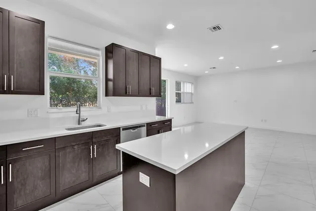 a kitchen with a sink and a refrigerator