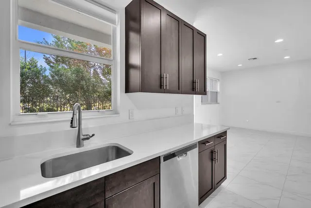 a kitchen with stainless steel appliances a sink and a window