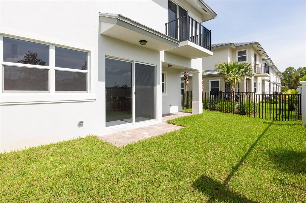 6947 Pines Circle, Unit 21 Pompano Beach, FL 33073 - Photo 15 of 31 a view of a white house with a big yard and large tree