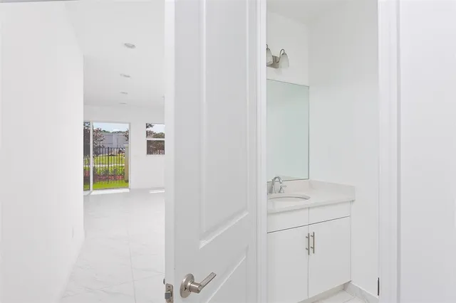 a view of a walk in closet and bathroom