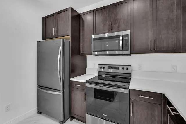a kitchen with a refrigerator stove and microwave