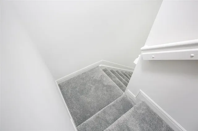 a bathroom with a double vanity sink a toilet a bathtub and shower